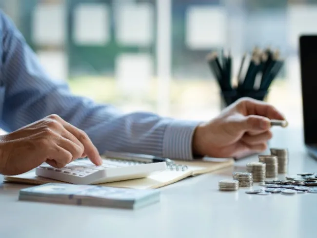 man saving stacks of coins